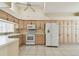 Spacious kitchen with white appliances, light wood cabinets, and tile flooring at 2216 Evans Rd, Clearwater, FL 33763