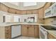Well-lit kitchen featuring sleek countertops, white appliances, and light-colored cabinetry at 2216 Evans Rd, Clearwater, FL 33763