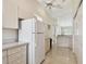 Bright kitchen with ample cabinet space, tile floors and a large refrigerator, great for cooking and storage at 2216 Evans Rd, Clearwater, FL 33763