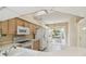 Bright and airy kitchen featuring updated appliances, white cabinets, and a cozy breakfast nook at 2216 Evans Rd, Clearwater, FL 33763