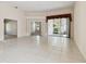 Large open living area with tile floors, decorative columns, and a seamless flow to outdoor living at 2216 Evans Rd, Clearwater, FL 33763