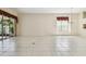 Bright living room featuring tiled flooring, large windows, and elegant chandelier lighting at 2216 Evans Rd, Clearwater, FL 33763