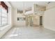 Bright and airy living space with tile floors, chandelier, and open layout to the front entrance at 2216 Evans Rd, Clearwater, FL 33763
