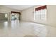 Spacious living room with tile floors, large window and elegant chandelier at 2216 Evans Rd, Clearwater, FL 33763