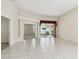 Inviting living room with tile floors, decorative columns, and access to screened-in lanai at 2216 Evans Rd, Clearwater, FL 33763