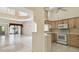 Open-concept living room and kitchen featuring tiled floors, high ceilings and outdoor access at 2216 Evans Rd, Clearwater, FL 33763