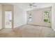 Bright main bedroom with ceiling fan, two windows, and an en-suite bathroom at 2216 Evans Rd, Clearwater, FL 33763