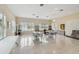 Large meeting space filled with bright natural light, tables, chairs, and tile floors at 2216 Evans Rd, Clearwater, FL 33763