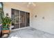 Screened patio features a sliding glass door to the home's interior and lovely landscaping at 2216 Evans Rd, Clearwater, FL 33763