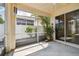 Covered patio featuring lovely landscaping with views to the backyard, patio furniture, and fence at 2216 Evans Rd, Clearwater, FL 33763