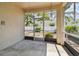 Enclosed patio with views to the landscaped backyard including the lawn and shrubs at 2216 Evans Rd, Clearwater, FL 33763