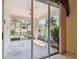 Enclosed patio with a ceiling fan and sliding glass doors offering views of the yard at 2216 Evans Rd, Clearwater, FL 33763