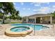 Community pool area with a hot tub, surrounded by a brick patio and offering a relaxing and social gathering space at 2216 Evans Rd, Clearwater, FL 33763