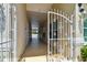Exterior walkway featuring decorative gates, providing an inviting entrance with an open view of the pool and surroundings at 2216 Evans Rd, Clearwater, FL 33763