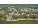 Overhead shot of residences nestled among lush trees along a peaceful lake, emphasizing nature at 2617 Heatherwood Dr, Tampa, FL 33618