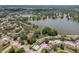 Beautiful aerial view of lakeside neighborhood showcasing homes and tranquil lake with lush green surroundings at 2617 Heatherwood Dr, Tampa, FL 33618