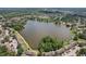 Expansive aerial view of a serene lake bordered by lush trees and charming residential neighborhoods at 2617 Heatherwood Dr, Tampa, FL 33618