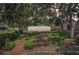 Charming backyard view with a well-maintained lawn and a brick path leading to the house at 2617 Heatherwood Dr, Tampa, FL 33618