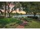 Landscaped backyard with lake view and beautiful brick path at 2617 Heatherwood Dr, Tampa, FL 33618