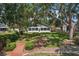 Charming backyard view with a well-maintained lawn and a brick path leading to the house at 2617 Heatherwood Dr, Tampa, FL 33618