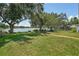 Expansive backyard with a lake view, featuring a well-maintained lawn and mature trees at 2617 Heatherwood Dr, Tampa, FL 33618