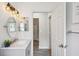 Bathroom with a marble vanity top, rustic lighting fixtures, and views to the hallway at 2617 Heatherwood Dr, Tampa, FL 33618