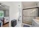 Bathroom with a stylish vanity, sleek glass shower, and access to the primary bedroom at 2617 Heatherwood Dr, Tampa, FL 33618