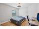 Comfortable bedroom with hardwood floors, a modern ceiling fan and dedicated workspace at 2617 Heatherwood Dr, Tampa, FL 33618