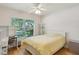 Bright bedroom features a large window offering lots of natural light and light hardwood floors at 2617 Heatherwood Dr, Tampa, FL 33618