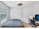 Bedroom features hardwood floors, ceiling fan, and a dedicated workspace at 2617 Heatherwood Dr, Tampa, FL 33618