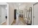 Inviting entryway with wood-look tile floors, decorative console table and rustic bench with coat rack at 2617 Heatherwood Dr, Tampa, FL 33618