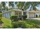 Beautiful home with a two-car garage and well-maintained landscaping, highlighting its curb appeal at 2617 Heatherwood Dr, Tampa, FL 33618