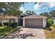 Inviting home with a manicured lawn and a gray two-car garage, showcasing its charming curb appeal at 2617 Heatherwood Dr, Tampa, FL 33618