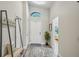 Bright foyer featuring wood-look flooring and a soaring arched window at 2617 Heatherwood Dr, Tampa, FL 33618
