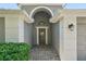 Inviting front entrance with a decorative 'hello' wreath and stone pathway at 2617 Heatherwood Dr, Tampa, FL 33618