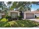Charming single-story home featuring a well-manicured lawn and a two-car garage at 2617 Heatherwood Dr, Tampa, FL 33618