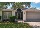 Charming single-story home featuring a well-manicured lawn and a two-car garage at 2617 Heatherwood Dr, Tampa, FL 33618