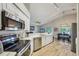 Bright kitchen view showcases stainless appliances and seamless flow to dining and living areas at 2617 Heatherwood Dr, Tampa, FL 33618