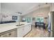 Bright kitchen features stainless steel appliances and white cabinets with a view of the dining area and backyard at 2617 Heatherwood Dr, Tampa, FL 33618