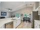 Bright kitchen features stainless steel appliances and white cabinets with a view of the dining area and backyard at 2617 Heatherwood Dr, Tampa, FL 33618