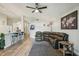 Inviting living room featuring a spacious sectional, modern ceiling fan, and stylish decor at 2617 Heatherwood Dr, Tampa, FL 33618
