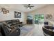 Open concept living room with comfortable leather seating and sliding glass doors to the lanai at 2617 Heatherwood Dr, Tampa, FL 33618