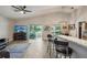 Open living space with bar seating, modern fixtures, and sliding doors to an outdoor area at 2617 Heatherwood Dr, Tampa, FL 33618