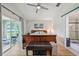 Relaxing main bedroom with a king bed, slider to the sunroom, and ensuite bathroom at 2617 Heatherwood Dr, Tampa, FL 33618