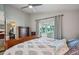 Relaxing main bedroom with a king bed, dressers, and slider to the sunroom with backyard view at 2617 Heatherwood Dr, Tampa, FL 33618