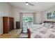 Relaxing main bedroom with a king bed, dressers, and slider to the sunroom with backyard view at 2617 Heatherwood Dr, Tampa, FL 33618