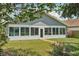 Back of home featuring sun room and brick path at 2617 Heatherwood Dr, Tampa, FL 33618