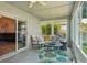 Comfortable sunroom featuring lots of windows and access to the main house at 2617 Heatherwood Dr, Tampa, FL 33618
