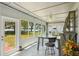 Bright sunroom with tile flooring, a ceiling fan, and stunning views of the lake at 2617 Heatherwood Dr, Tampa, FL 33618