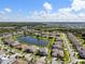 An aerial view of a residential community with lakes and green spaces at 33255 Kateland Dr, Wesley Chapel, FL 33545